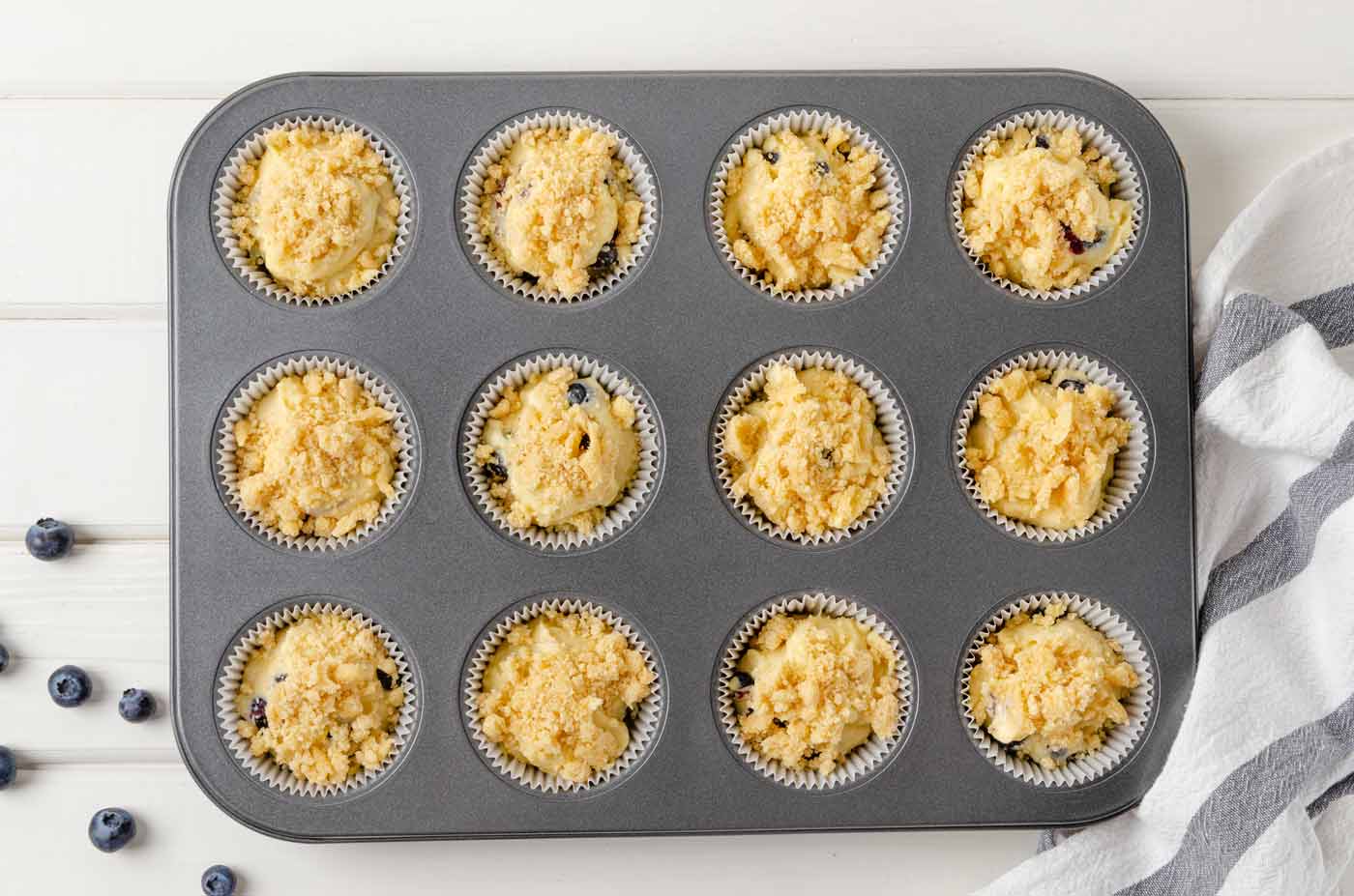 adding batter to muffin pan